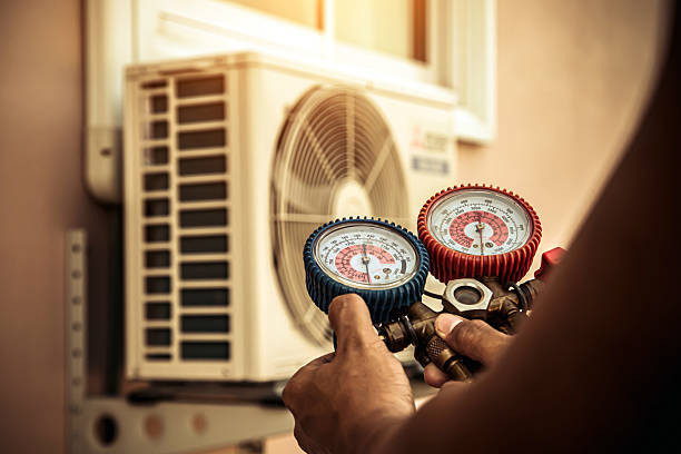 Professional Air Conditioning Service technician working in Newton Upper Falls, MA